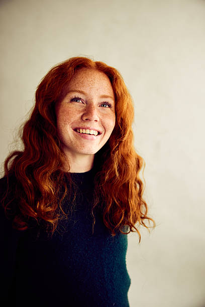 istock Cheerful female redhead in her 20s smiling, studio shot 2213469923