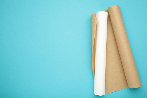istock Rolls of white and brown baking paper on blue background 2213470670