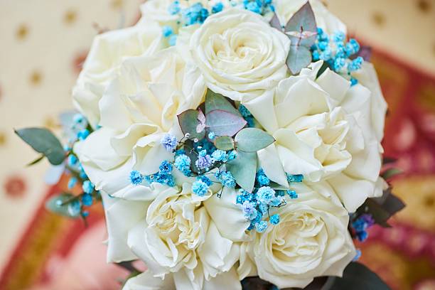 istock Bouquet of white roses with blue decoration 2213471859