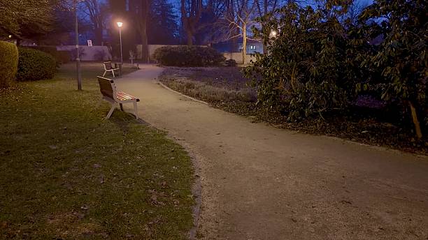 istock Enjoy a Serene Evening Stroll along a Quiet Park Pathway while soaking in the atmosphere 2213471985