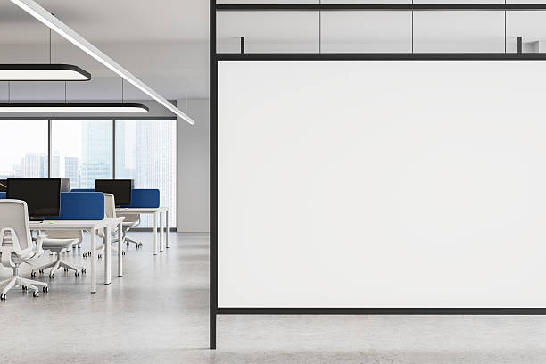 istock Modern office interior with large blank poster mockup on partition wall for corporate branding or advertisement display in workspace setting. 3D Rendering 2213472901