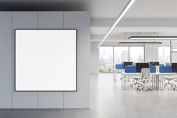 istock Blank poster mockup on wall in modern office interior with city view and open workspace environment featuring minimalist design elements. 3D Rendering 2213473679