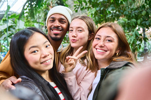 istock Group of young students taking a selfie in greenhouse 2213474908