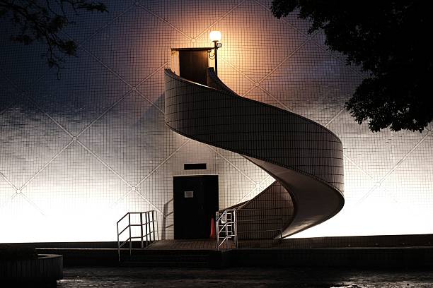 istock Modern spiral staircase illuminated at night. 2213475131