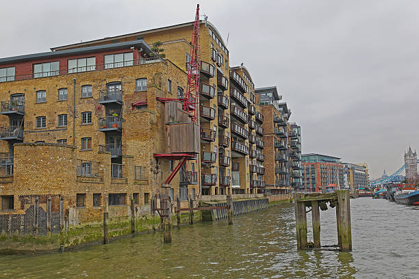 London, United Kingdom - January 25, 2013: New Residential Building Converted Warehouses China and Butlers Wharf at Thames River in Capital City at Cold Winter Day.