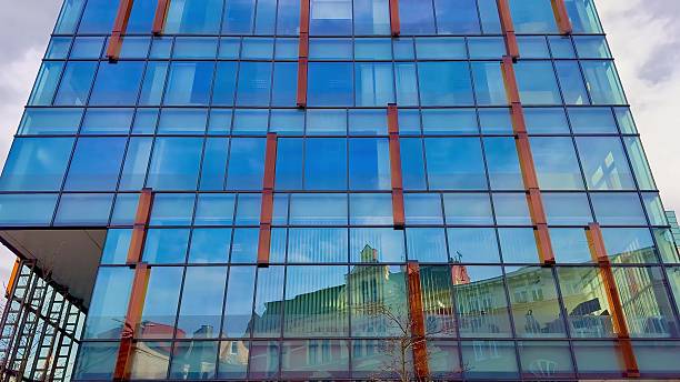 istock Contemporary Modern Glass Building Featuring Beautiful Reflections in a Vibrant Urban Setting 2213476279