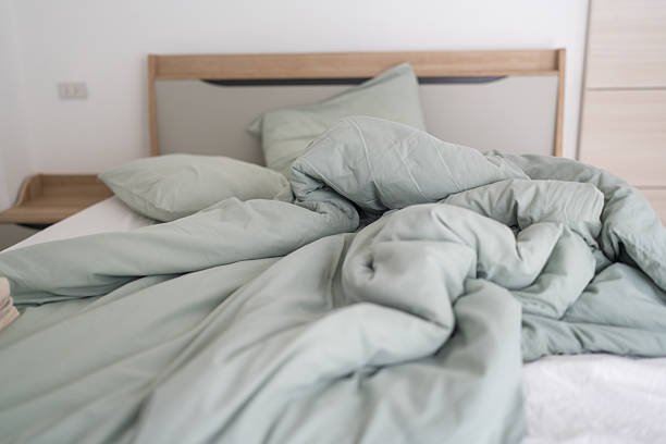 Wrinkled bed sheets and pillows after waking up in early morning