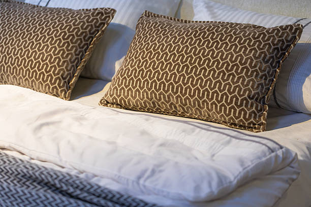 istock Closeup of cushions on bed 2213477012