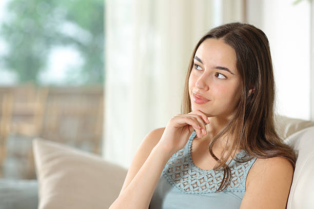 istock Woman is thinking and looking at side at home 2213477192