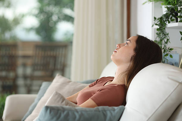 istock Apathetic woman sitting on a sofa at home 2213477377