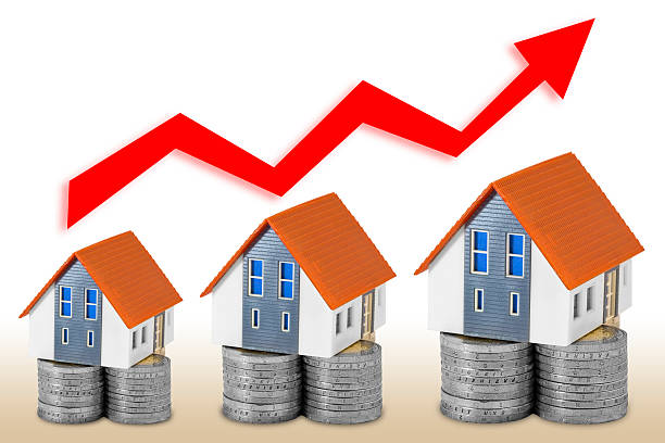 istock REAL ESTATE MARKET TRENDS - Concept with home models and increasing graph 2213477615