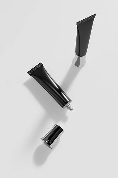 istock cylindrical shape skincare lotion packaging, black tube packging mockup, glossy dark plastic soft tube with nozzle tip, tubular makeup tube with dropper head, luxury makeup product container 2213480267