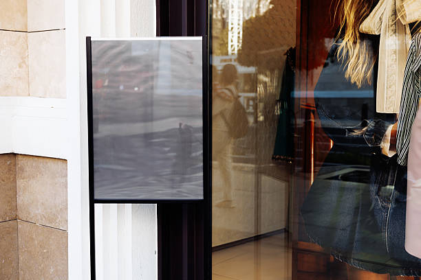 istock Storefront featuring a window display with mannequins and clothing in an urban setting 2213481347
