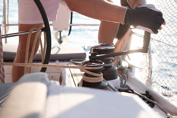 istock Man working on sailing yacht ropes and winch. 2213481515
