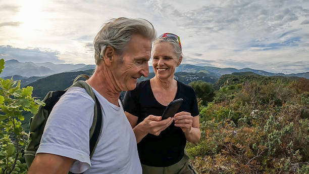 istock Mature couple hike across green ridge crest 2213481997