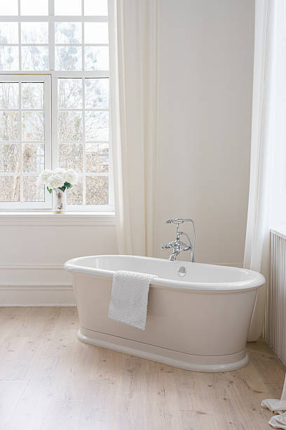 istock Modern elegant minimalist bathroom interior with curtains and window and freestanding bathtub 2213483611
