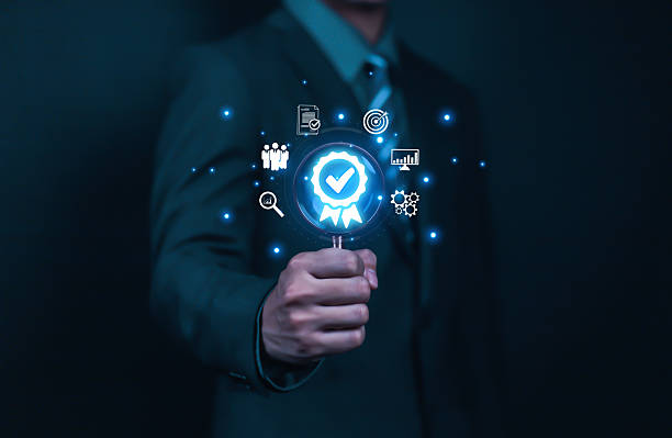 istock Businessman holding quality certification mark, audit, business, assurance, control, digital, service, complete, assessment, checklist, data with quality icon. 2213483694