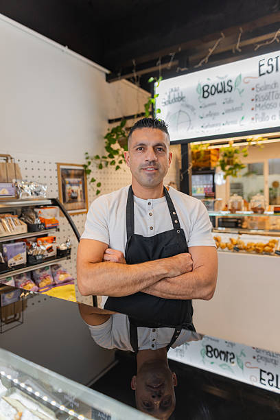 istock Confident bakery owner standing behind the counter 2213484850