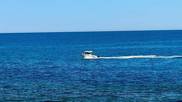 istock A speeding boat glides effortlessly across the clear and inviting ocean waters under a bright sky 2213487068