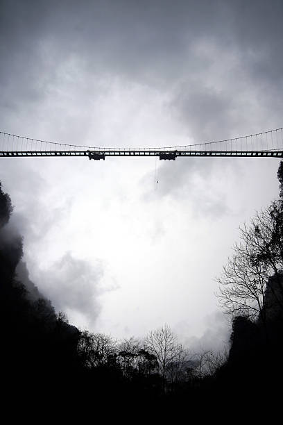 istock Bungee Jump from a Bridge Under Cloudy Sky 2213487296