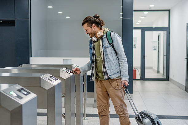 istock Tourist passing through automatic gates at airport terminal 2213487910
