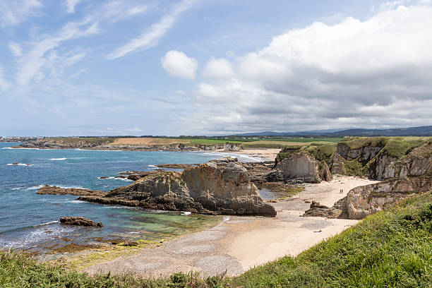 istock Scenic coastal landscape showing cliffs, beaches, and lush green hills under a cloudy sky 2213488982