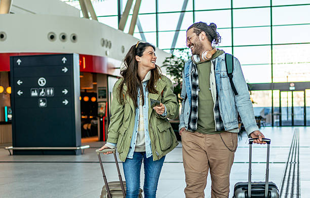 istock Tourists walking with suitcases in the train station 2213489124