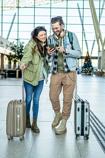 istock Tourists couple using smartphone in the train station 2213489513
