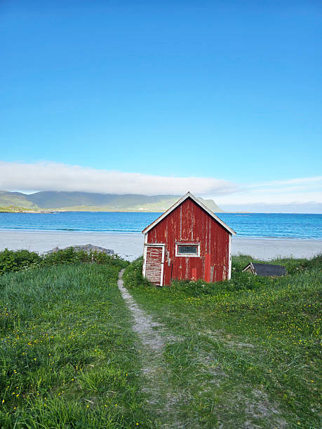 istock Charming red cabin by the tranquil beach in Norway with stunning coastal views 2213501772