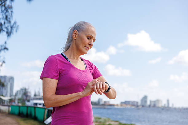 istock Mature woman checking smartwatch before exercising 2213503696