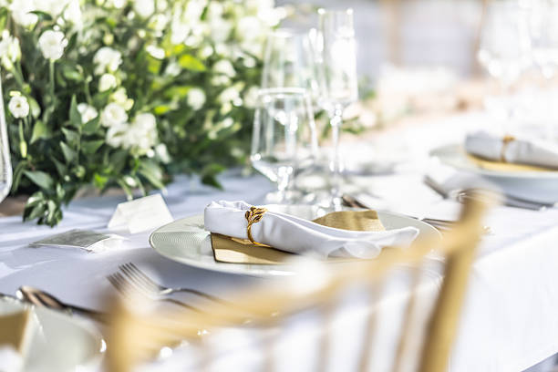 istock A wedding table covered with a white tablecloth, decorated with flowers, candles, glasses and cutlery 2213503981