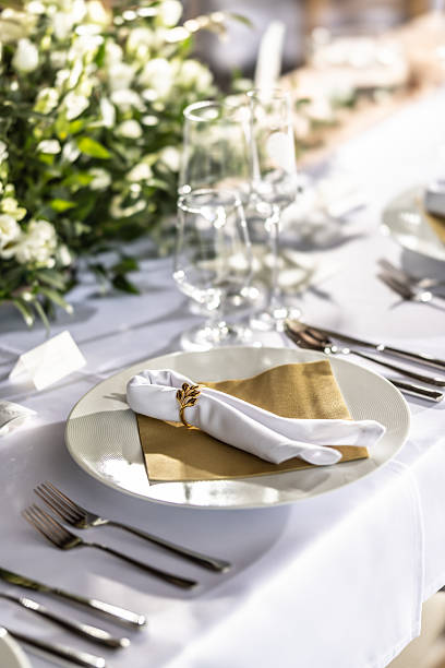 istock A wedding table covered with a white tablecloth, decorated with flowers, candles, glasses and cutlery 2213504016