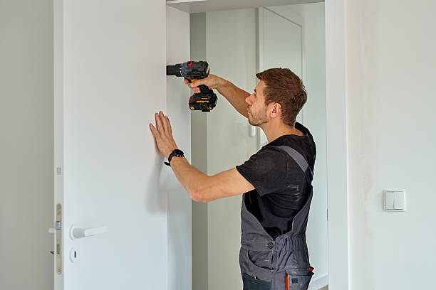 istock Man installs door in apartment during renovation, using cordless screwdriver 2213504625