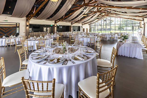 istock Wedding setting and decorated tables in a beautiful modern interior of a performance hall with a modern light ceiling of wooden construction 2213505092