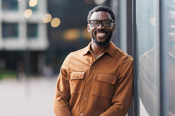 istock Smiling confident man wearing glasses standing outside an office building 2213505405