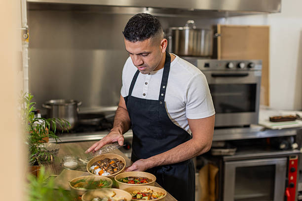 istock Chef Packing Takeaway Meals in a Professional Kitchen 2213509830