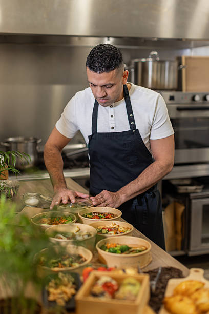 istock Chef Preparing Takeaway Meals in a Professional Kitchen 2213509834