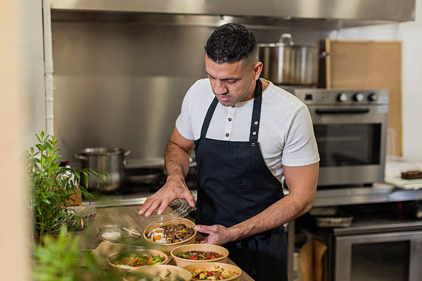 istock Chef Preparing Takeaway Meals in a Professional Kitchen 2213509839