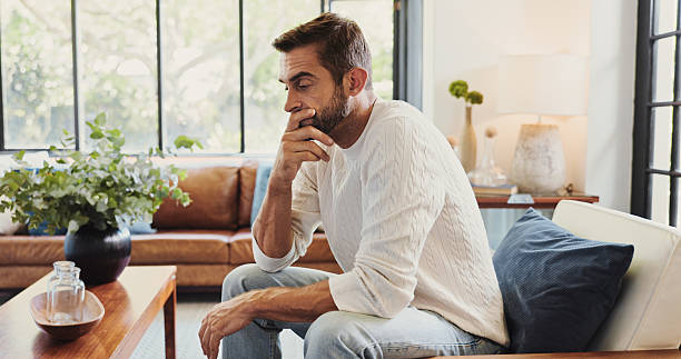 istock Thinking, crisis and man in home with stress for bankruptcy, financial challenge or difficult decision. Sad, worry and person with concern for doubt, mistake or debt with reflection for mental health 2213514267