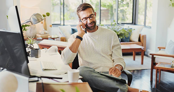 istock Phone call, remote work and tablet with man in home office for communication, planning or update. Computer, conversation and research with freelance entrepreneur in apartment for startup development 2213514476