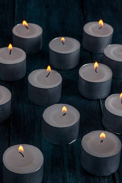 istock Tea light candles on a dark background, many lights in the dark 2213516881