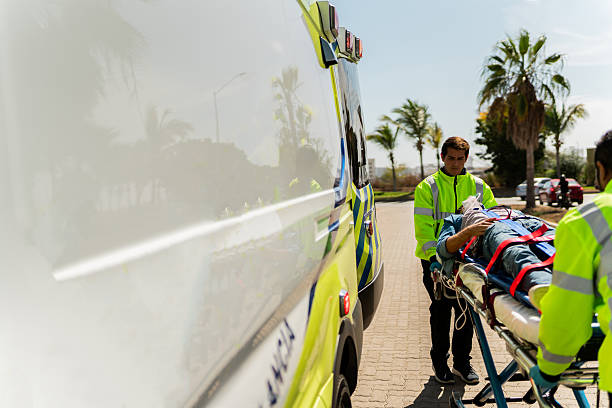 Paramedic helping victim outdoors