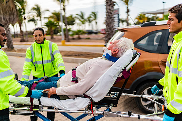 Paramedic helping senior victim on car accident