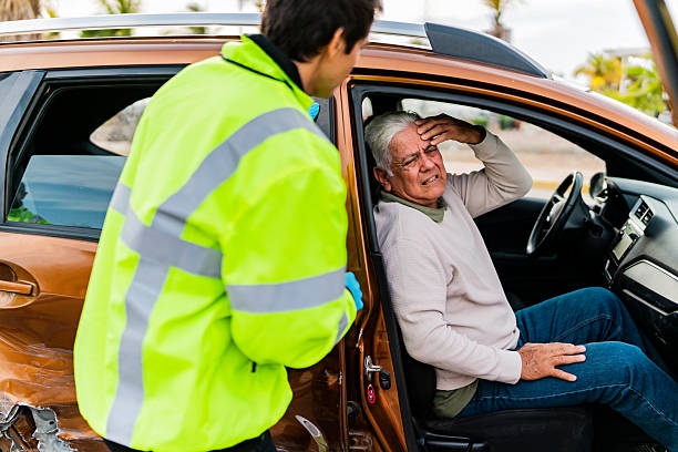 Paramedic helping senior victim on car accident