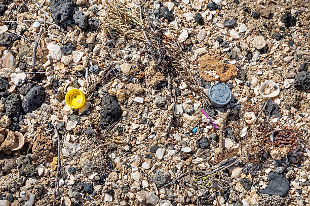 Textured surface of light gray stones and black asphalt chips. The plane is divided in half.