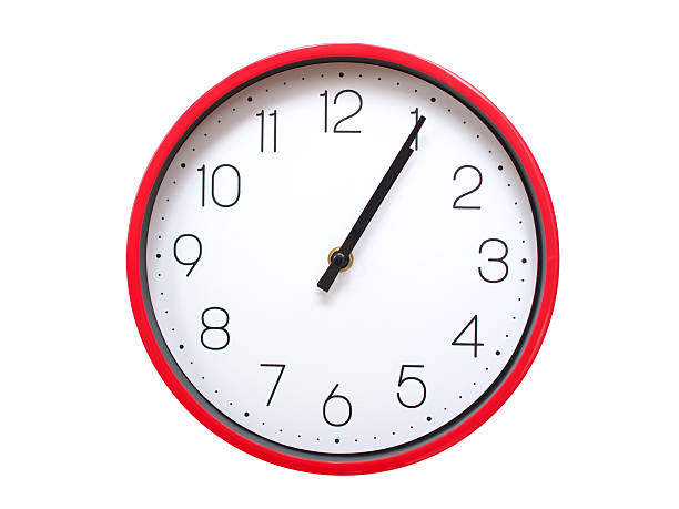 Minimalist red framed wall clock pointing at 01:05 or 13:05. Isolated on white background. Concept of time management.