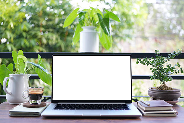 istock Laptop white screen mock up, cozy balcony workspace and coffee cup 2213524786