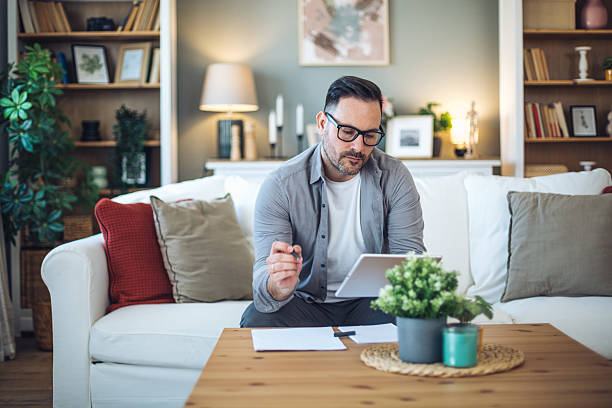 istock Mid adult man working remotely from home 2213529222