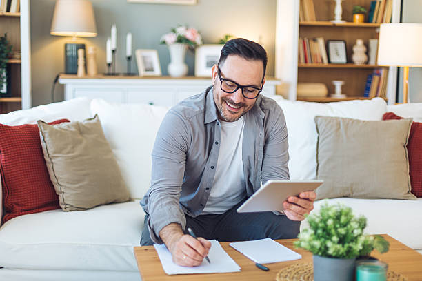 istock Mid adult man working from home with tablet 2213530085