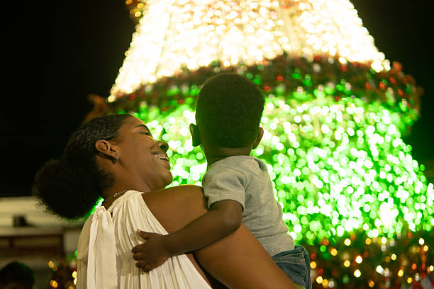 istock Mother and son admiring christmas tree lights at night 2213539205